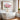 Australian pink flowering gum wall art in a frame over a freestanding bath in a bright neutral bathroom