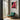 Red flowering gum wall art in a room with a teal chair and large window