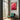Red flowering gum photography print wall art in a room with large windows and a green chair