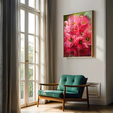 Red flowering gum photography print wall art in a room with large windows and a green chair